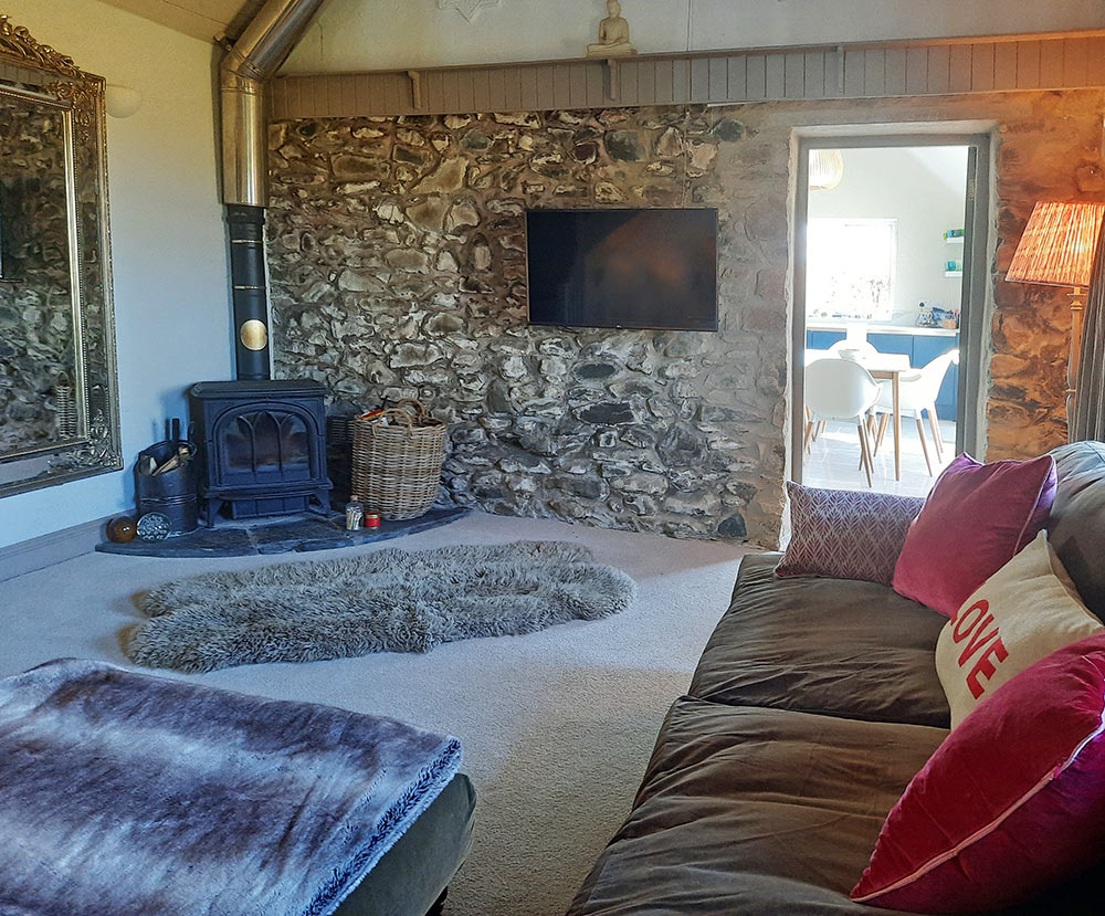 The cosy living area with a wood burning stove The cosy living area with a wood burning stove