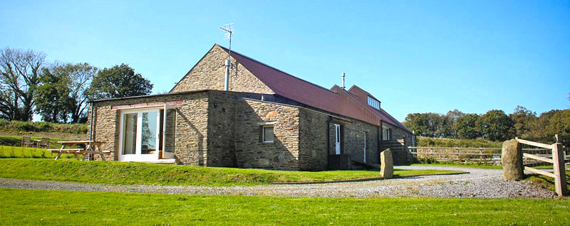 Penpedwast Cottages, set against the woodlands